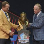 Peyton Manning, left, a member of the Pro Football Hall of Fame Class of 2021, and his presenter and father Archie Manning unveil a bust of Peyton during the induction ceremony at the Pro Football Hall of Fame, Sunday, Aug. 8, 2021, in Canton, Ohio. (AP Photo/David Richard)