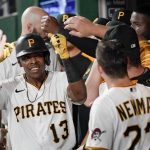 Pittsburgh Pirates Ke'Bryan Hayes (13) celebrates with teammates in the dugout after driving in Kevin Newman (27) with a ground out in the eighth inning of a baseball game against the Arizona Diamondbacks, Monday, Aug. 23, 2021, in Pittsburgh. The Pirates won 6-5. (AP Photo/Keith Srakocic)