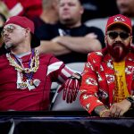 An Arizona Cardinals and an Kansas City Chiefs fan watch during the first half of an NFL football game, Friday, Aug. 20, 2021, in Glendale, Ariz. (AP Photo/Ross D. Franklin)