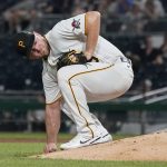 Pittsburgh Pirates starting pitcher Wil Crowe picks up dirt behind the mound after giving up a hit to Arizona Diamondbacks' Ketel Martels that drove in a run in the fifth inning of a baseball game, Monday, Aug. 23, 2021, in Pittsburgh. (AP Photo/Keith Srakocic)
