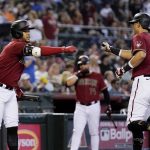 Arizona Diamondbacks' Josh Rojas (10) celebrates his home run against the San Diego Padres with teammate Ketel Marte during the fifth inning of a baseball game, Sunday, Aug. 15, 2021, in Phoenix. (AP Photo/Ross D. Franklin)
