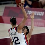Japan's Nako Motohashi (15), right, attempts to block United States' Diana Taurasi (12) during women's basketball gold medal game at the 2020 Summer Olympics, Sunday, Aug. 8, 2021, in Saitama, Japan. (AP Photo/Luca Bruno)