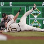 Arizona Diamondbacks shortstop Nick Ahmed, rear, tags out Pittsburgh Pirates' Bryan Reynolds at second during the fifth inning of a baseball game, Tuesday, Aug. 24, 2021, in Pittsburgh. (AP Photo/Keith Srakocic)