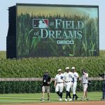 Chicago White Sox players walk on the field before a baseball game against the New York Yankees, Thursday, Aug. 12, 2021, in Dyersville, Iowa. The Yankees and White Sox are playing at a temporary stadium in the middle of a cornfield at the Field of Dreams movie site, the first Major League Baseball game held in Iowa. (AP Photo/Charlie Neibergall)