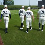 Chicago White Sox players Michael Kopech (34), Aaron Bummer (39), Andrew Vaughn (25) and Zack Collins (21) walk on the field before a baseball game against the New York Yankees, Thursday, Aug. 12, 2021, in Dyersville, Iowa. The Yankees and White Sox are playing at a temporary stadium in the middle of a cornfield at the Field of Dreams movie site, the first Major League Baseball game held in Iowa. (AP Photo/Charlie Neibergall)