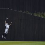 New York Yankees left fielder Brett Gardner jumps to catch Chicago White Sox's Eloy Jimenez fly ball during a baseball game, Thursday, Aug. 12, 2021 in Dyersville, Iowa. The Yankees and White Sox are playing at a temporary stadium in the middle of a cornfield at the Field of Dreams movie site, the first Major League Baseball game held in Iowa. (AP Photo/Charlie Neibergall)