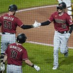 Arizona Diamondbacks' Pavin Smith (26) is greeted by Josh VanMeter (19) and Christian Walker (53) after hitting a solo home run against the Pittsburgh Pirates during the sixth inning of a baseball game Wednesday, Aug. 25, 2021, in Pittsburgh. (AP Photo/Keith Srakocic)