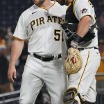 Pittsburgh Pirates relief pitcher David Bednar (51) celebrates with catcher Jacob Stallings (58) after getting the last out against the Arizona Diamondbacks in the ninth inning of a baseball game, Monday, Aug. 23, 2021, in Pittsburgh. The Pirates won 6-5. (AP Photo/Keith Srakocic)