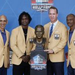 From left to right, Tony Dungy, Edgerrin James, Peyton Manning and Marvin Harrison pose with a bust of Manning during the induction ceremony at the Pro Football Hall of Fame, Sunday, Aug. 8, 2021, in Canton, Ohio. (AP Photo/Ron Schwane, Pool)