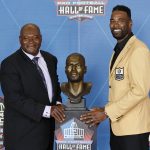 Calvin Johnson, a member of the Pro Football Hall of Fame Class of 2021, right, poses with his presenter Derrick Moore during the induction ceremony at the Pro Football Hall of Fame, Sunday, Aug. 8, 2021, in Canton, Ohio. (AP Photo/Ron Schwane, Pool)