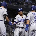 Los Angeles Dodgers' Justin Turner celebrates with Corey Seager (5) and Chris Taylor (3) after scoring runs on a double hit by Albert Pujols in the second inning of a baseball game against the Arizona Diamondbacks, Sunday, Aug 1, 2021, in Phoenix. (AP Photo/Rick Scuteri)
