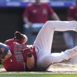 Arizona Diamondbacks pinch hitter Asdrubal Cabrera drops in the batter's box to avoid an inside pitch from Colorado Rockies relief pitcher Yency Almonte in the ninth inning of a baseball game Sunday, Aug. 22, 2021, in Denver. (AP Photo/David Zalubowski)