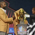 Charles Woodson, a member of the Pro Football Hall of Fame Class of 2021, left, unveils the bust with his presenter and mother Georgia Woodson during the induction ceremony at the Pro Football Hall of Fame, Sunday, Aug. 8, 2021, in Canton, Ohio. (AP Photo/David Richard)