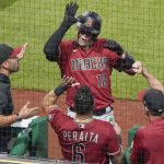 Arizona Diamondbacks' Carson Kelly (18) celebrates with his teammates in the dugout after hitting a pinch-hit home run against the Pittsburgh Pirates during the seventh inning of a baseball game Wednesday, Aug. 25, 2021, in Pittsburgh. (AP Photo/Keith Srakocic)