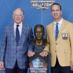 Peyton Manning, right, a member of the Pro Football Hall of Fame Class of 2021, poses with his presenter and father Archie Manning during the induction ceremony at the Pro Football Hall of Fame, Sunday, Aug. 8, 2021, in Canton, Ohio. (AP Photo/Ron Schwane, Pool)