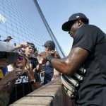 Chicago White Sox shortstop Tim Anderson signs autographs before a baseball game against the New York Yankees, Thursday, Aug. 12, 2021 in Dyersville, Iowa. The Yankees and White Sox are playing at a temporary stadium in the middle of a cornfield at the Field of Dreams movie site, the first Major League Baseball game held in Iowa. (AP Photo/Charlie Neibergall)