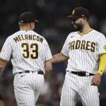 San Diego Padres first baseman Eric Hosmer, right, and relief pitcher Mark Melancon react during the ninth inning of the team's baseball game against the Arizona Diamondbacks, Saturday, Aug. 7, 2021, in San Diego. (AP Photo/Derrick Tuskan)
