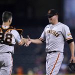 San Francisco Giants relief pitcher Jake McGee, right, shakes hands with catcher Buster Posey after the team's 5-4 win over Arizona Diamondbacks in 10 innings in a baseball game Thursday, Aug. 5, 2021, in Phoenix. (AP Photo/Ross D. Franklin)
