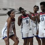 United States players pose for photos after their win in the women's basketball gold medal game against Japan at the 2020 Summer Olympics, Sunday, Aug. 8, 2021, in Saitama, Japan. (AP Photo/Luca Bruno)