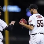 Arizona Diamondbacks relief pitcher Jake Faria (55) celebrates with catcher Carson Kelly after the team's 12-3 win in a baseball game against the San Diego Padres, Thursday, Aug. 12, 2021, in Phoenix. (AP Photo/Ross D. Franklin)