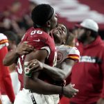 Kansas City Chiefs wide receiver Demarcus Robinson and Arizona Cardinals tight end Demetrius Harris, left, embrace after an NFL football game, Friday, Aug. 20, 2021, in Glendale, Ariz. The Chiefs won 17-10. (AP Photo/Rick Scuteri)