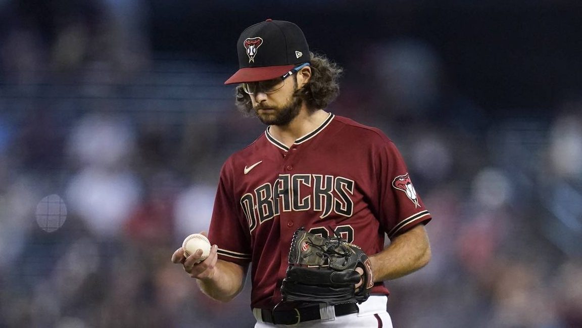 Arizona Diamondbacks starting pitcher Zac Gallen looks at a new ball after giving up a home run to ...