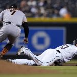 San Francisco Giants second baseman Donovan Solano (7) tags out Arizona Diamondbacks' Nick Ahmed (13) in a rundown during the fourth inning of a baseball game Tuesday, Aug. 3, 2021, in Phoenix. (AP Photo/Ross D. Franklin)