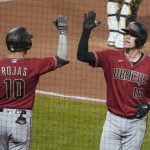 Arizona Diamondbacks' Carson Kelly (18) is greeted by Josh Rojas after hitting a solo home run against the Pittsburgh Pirates during the seventh inning of a baseball game, Wednesday, Aug. 25, 2021, in Pittsburgh. (AP Photo/Keith Srakocic)