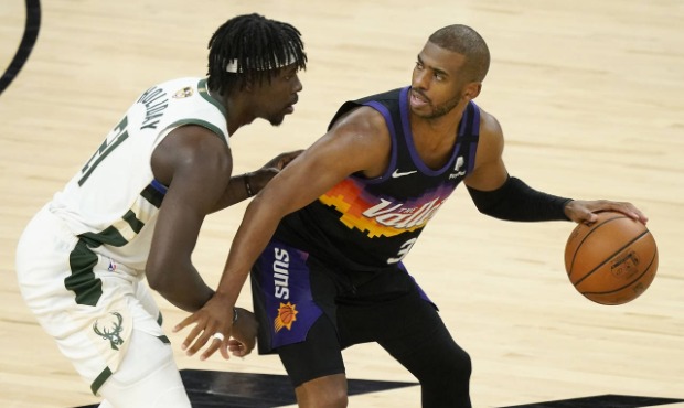 Phoenix Suns guard Chris Paul, right, is defended by Milwaukee Bucks guard Jrue Holiday during the ...