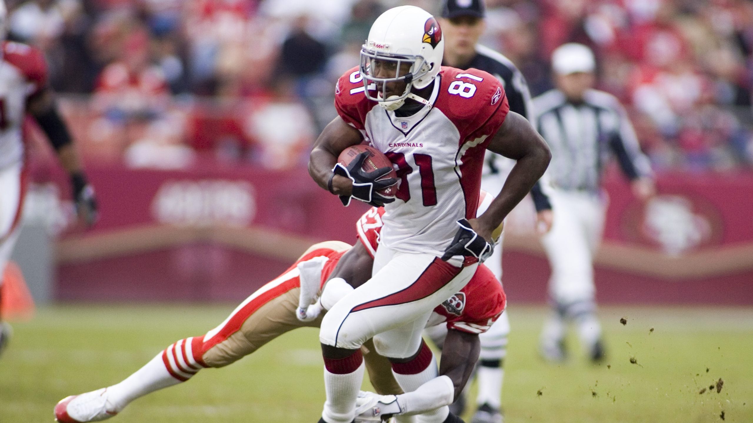Anquan Boldin wide receiver for the Arizona Cardinals breaks a tackle by #27 Walt Harris in a game ...