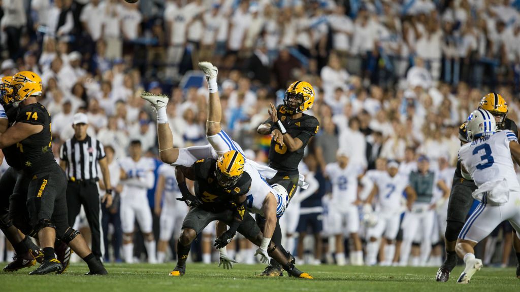 Rachaad White #3 of the Arizona State Sun Devils up ends Keenan Pili $41of the BYU Cougars as he pr...
