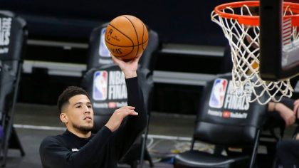 Devin Booker #1 of the Phoenix Suns warms up before Game Two of the NBA finals against the Milwauke...