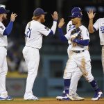 The Los Angeles Dodgers celebrate after a 5-3 win over the Arizona Diamondbacks in a baseball game Wednesday, Sept. 15, 2021, in Los Angeles. (AP Photo/Ashley Landis)
