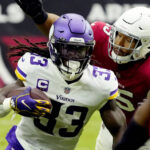 Minnesota Vikings running back Dalvin Cook (33) avoids the tackles of Arizona Cardinals linebacker Zaven Collins during the first half of an NFL football game, Sunday, Sept. 19, 2021, in Glendale, Ariz. (AP Photo/Rick Scuteri)