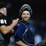 Seattle Mariners catcher Tom Murphy, right, smiles as he talks with home plate umpire Ted Barrett during the third inning of a baseball game against the Arizona Diamondbacks, Sunday, Sept. 5, 2021, in Phoenix. (AP Photo/Ross D. Franklin)