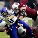 Minnesota Vikings quarterback Kirk Cousins (8) recovers his own fumble as Arizona Cardinals linebacker Markus Golden and defensive end J.J. Watt (99) make the hit during the second half of an NFL football game, Sunday, Sept. 19, 2021, in Glendale, Ariz. (AP Photo/Ross D. Franklin)