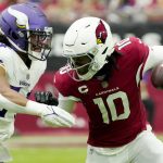 Arizona Cardinals wide receiver DeAndre Hopkins (10) tries to elude the tackle of Minnesota Vikings middle linebacker Eric Kendricks during the first half of an NFL football game, Sunday, Sept. 19, 2021, in Glendale, Ariz. (AP Photo/Rick Scuteri)