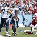 Tennessee Titans wide receiver A.J. Brown, center, is congratulated by tight end Geoff Swaim (87) after Brown scored a touchdown against the Arizona Cardinals in the second half of an NFL football game Sunday, Sept. 12, 2021, in Nashville, Tenn. (AP Photo/Wade Payne)