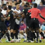 An official, right, tries to break up a scuffle between players during the first half of a World Cup soccer qualifier between the United States and Canada Sunday, Sept. 5, 2021, in Nashville, Tenn. (AP Photo/Mark Humphrey)