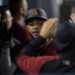 Arizona Diamondbacks' Ketel Marte celebrates in the dugout after scoring off of a single hit by Henry Ramos during the fourth inning of a baseball game against the Los Angeles Dodgers Wednesday, Sept. 15, 2021, in Los Angeles. (AP Photo/Ashley Landis)