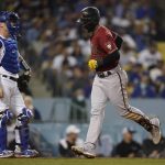 Arizona Diamondbacks' Christian Walker (53) scores after hitting a home run during the sixth inning of a baseball game against the Los Angeles Dodgers Wednesday, Sept. 15, 2021, in Los Angeles. (AP Photo/Ashley Landis)