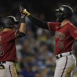 Arizona Diamondbacks' Christian Walker (53) celebrates with Josh Rojas (10) after hitting a home run during the sixth inning of a baseball game against the Los Angeles Dodgers Wednesday, Sept. 15, 2021, in Los Angeles. (AP Photo/Ashley Landis)