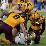
              Arizona State defensive players Merlin Robertson (8) D.J Davidson (98) and Darien Butler (20) smother Colorado State tailback Alex Fontenot (8) during the first half of an NCAA college football game  Saturday, Sept 25, 2021, in Tempe, Ariz. (AP Photo/Darryl Webb)
            