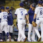 The Los Angeles Dodgers celebrate after a 5-3 win over the Arizona Diamondbacks in a baseball game Wednesday, Sept. 15, 2021, in Los Angeles. (AP Photo/Ashley Landis)