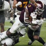 Arizona State running back Rachaad White (3) is hit by UNLV defensive back Bryce Jackson, right, during the first half of an NCAA college football game, Saturday, Sept. 11, 2021, in Tempe, Ariz. (AP Photo/Matt York)