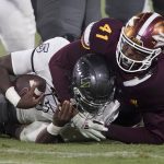 UNLV quarterback Justin Rogers (5) is sacked by Arizona State defensive lineman Tyler Johnson (41) during the second half of an NCAA college football game, Saturday, Sept. 11, 2021, in Tempe, Ariz. (AP Photo/Matt York)