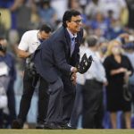 Former Los Angeles Dodgers pitcher Fernando Valenzuela catches the first pitch, thrown by his granddaughter, during a ceremony honoring him before a baseball game between the Arizona Diamondbacks and the Los Angeles Dodgers Wednesday, Sept. 15, 2021, in Los Angeles. (AP Photo/Ashley Landis)