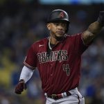 Arizona Diamondbacks' Ketel Marte points to Henry Ramos after scoring off of a single hit by Ramos during the fourth inning of a baseball game against the Los Angeles Dodgers Wednesday, Sept. 15, 2021, in Los Angeles. (AP Photo/Ashley Landis)