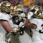 Colorado tailback Alex Fontenot (8) is mobbed by teammates after scoring a touchdown against Arizona State during the second half of an NCAA college football game Saturday, Sept. 25, 2021, in Tempe, Ariz. (AP Photo/Darryl Webb)
