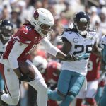 Arizona Cardinals wide receiver DeAndre Hopkins (10) runs after a reception against Jacksonville Jaguars defensive end Dawuane Smoot, left, cornerback Shaquill Griffin (26) and defensive end Malcolm Brown (90) during the first half of an NFL football game, Sunday, Sept. 26, 2021, in Jacksonville, Fla. (AP Photo/Phelan M. Ebenhack)